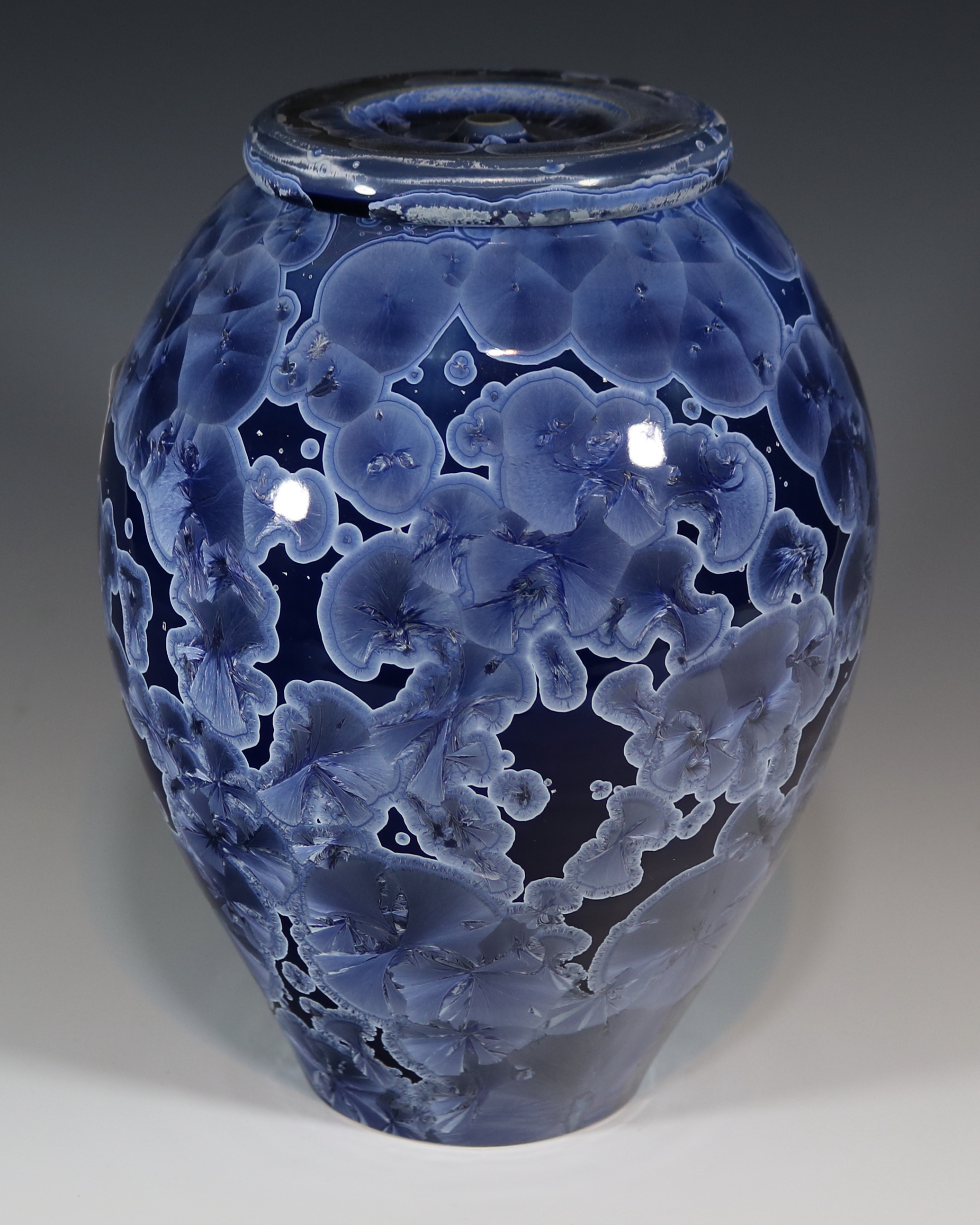 Large jar, white and dark blue background with blue crystals edged in white, 6.3" wide by 7.5" high, 131 cubic inches.